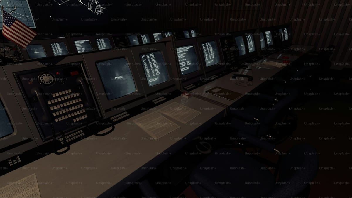 Array of broadcast monitors arranged on a control desk, the editorial visual metaphor for OTT and streaming operations