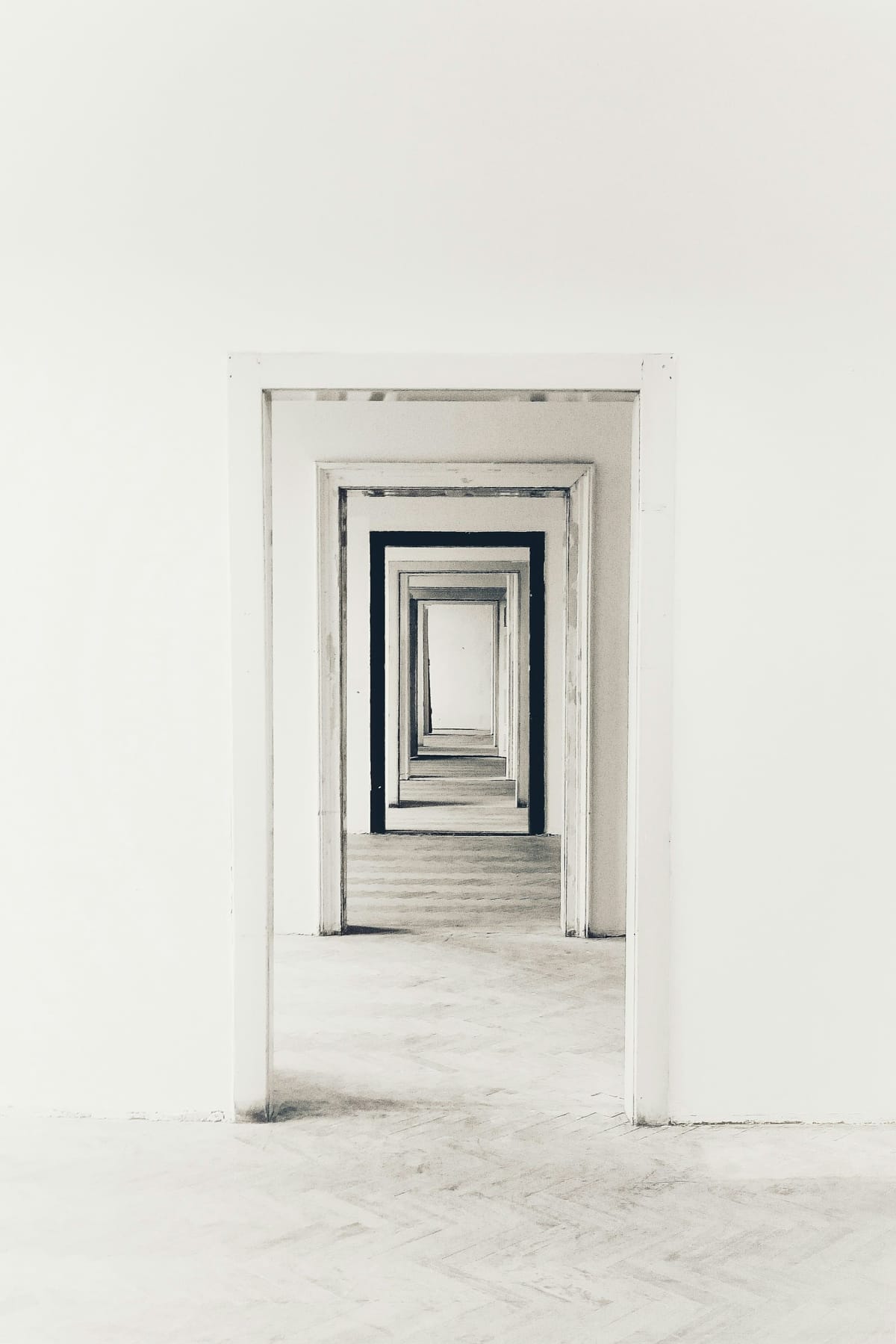 Minimal grey corridor with subtle spatial recession, used as an editorial metaphor for clarity and choice