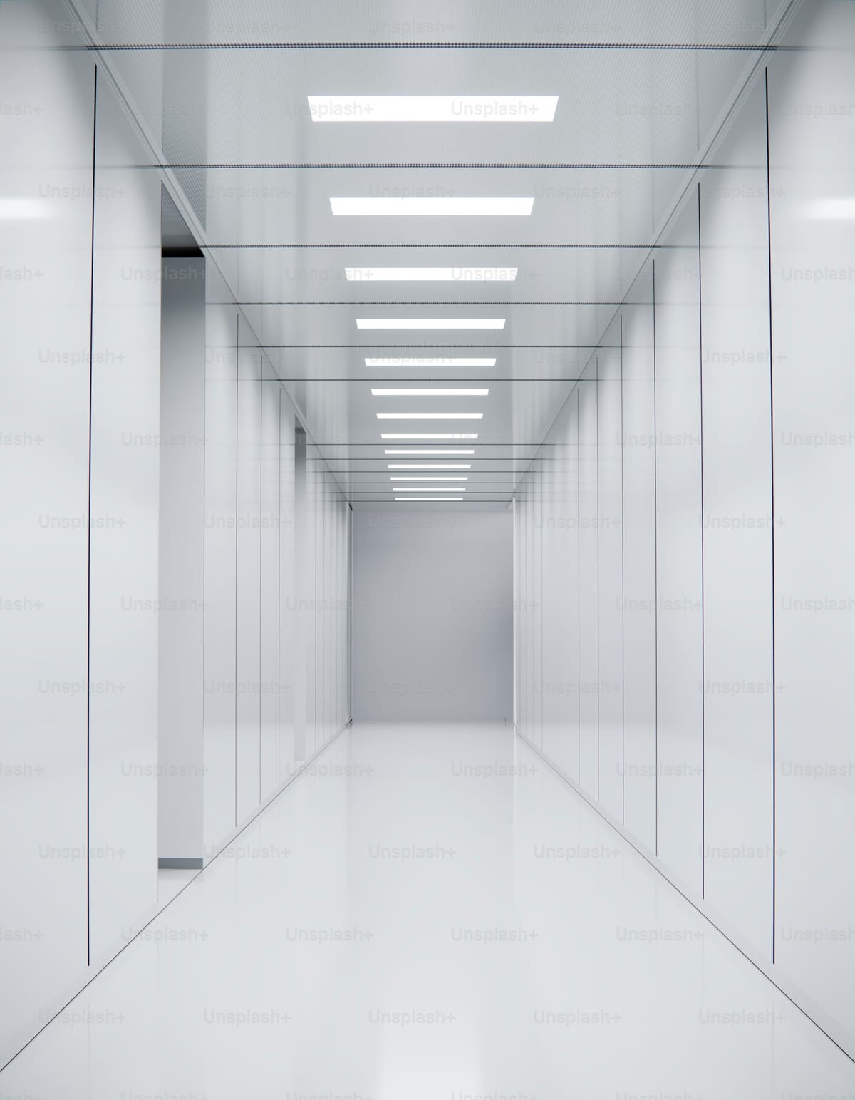 Long architectural passage with overhead ceiling lights, depicting depth and the long view that defines advisory work