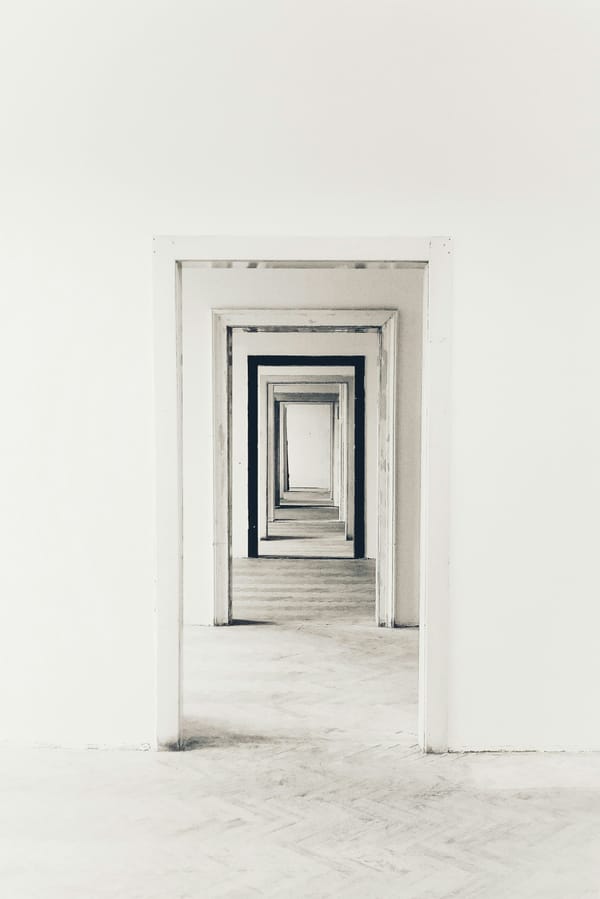 Minimal grey corridor with subtle spatial recession, used as an editorial metaphor for clarity and choice